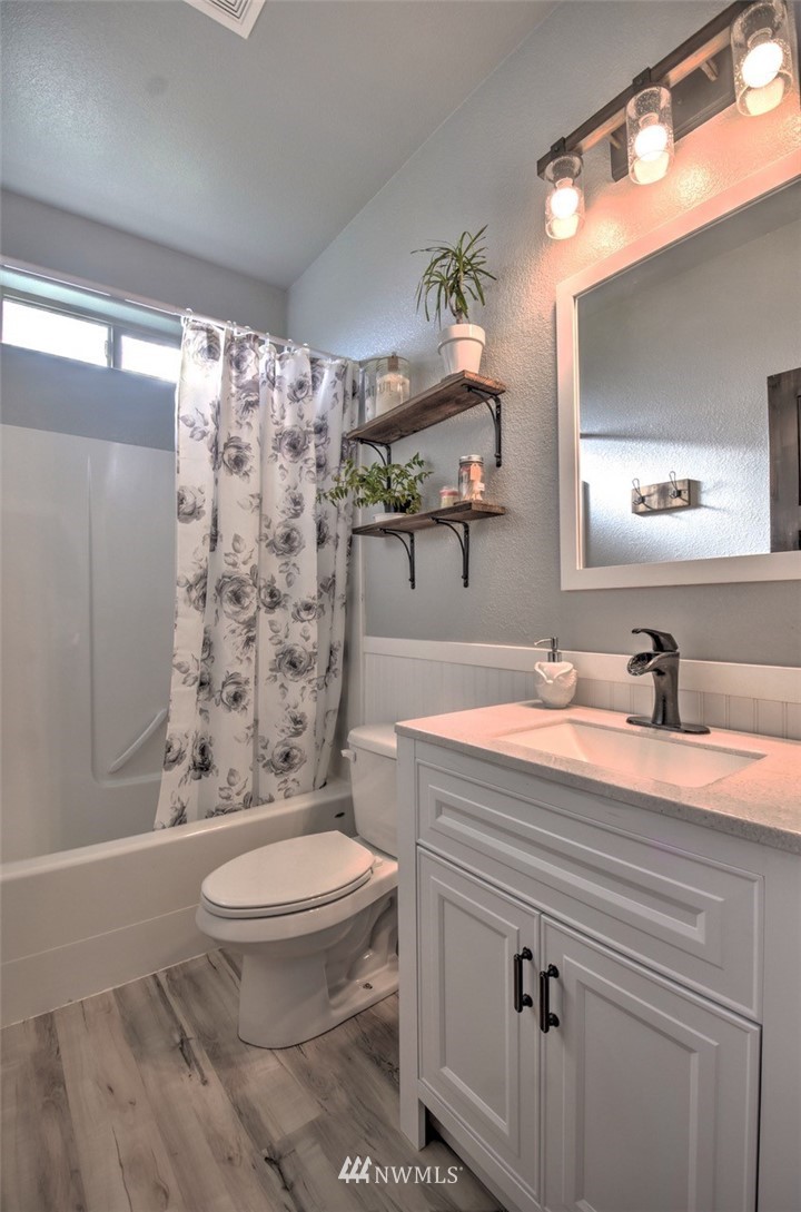 8637 183rd Avenue Southwest Rochester, WA 98579 - Photo 22 of 33 a bathroom with a sink a toilet a mirror and shower
