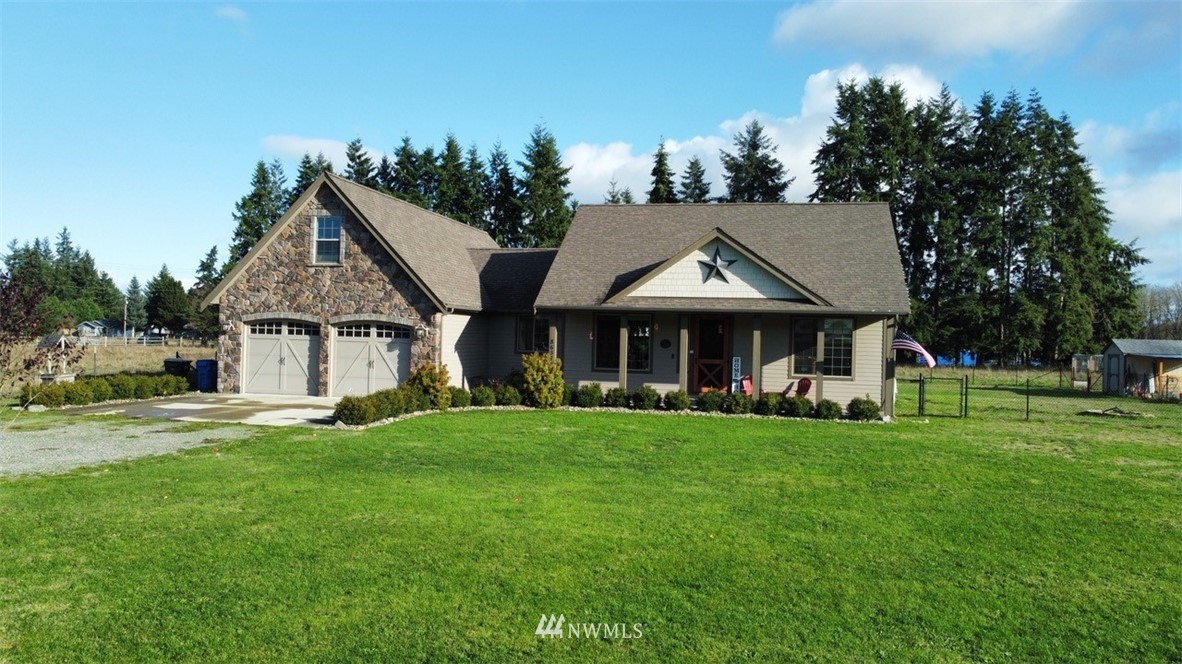 8637 183rd Avenue Southwest Rochester, WA 98579 - Photo 33 of 33 a front view of a house with a garden and trees