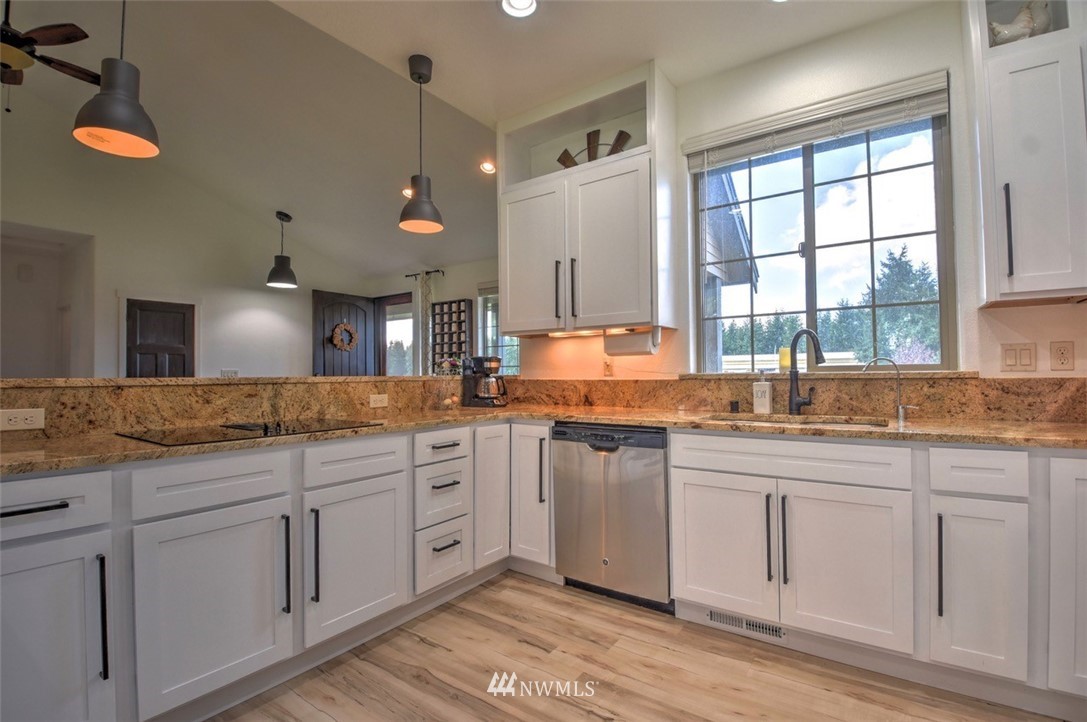 8637 183rd Avenue Southwest Rochester, WA 98579 - Photo 5 of 33 a kitchen with white cabinets and sink