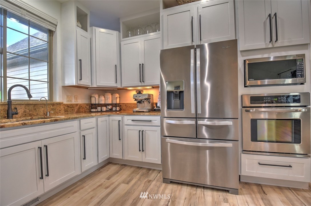 8637 183rd Avenue Southwest Rochester, WA 98579 - Photo 6 of 33 a kitchen with cabinets stainless steel appliances and window