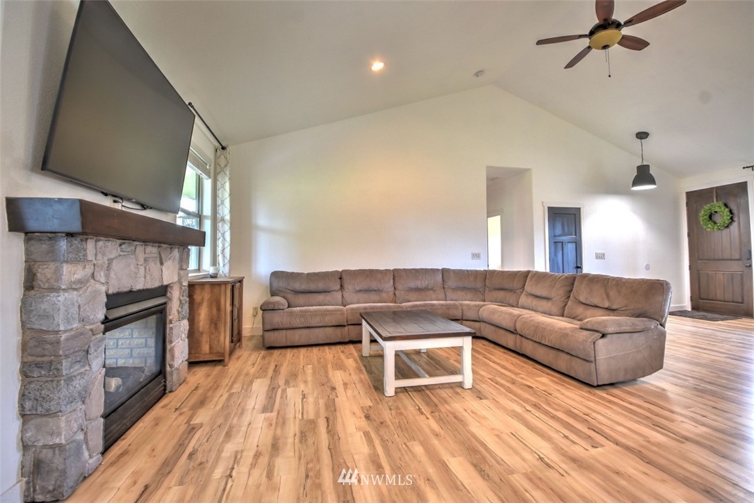 8637 183rd Avenue Southwest Rochester, WA 98579 - Photo 10 of 33 a living room with furniture and a fireplace