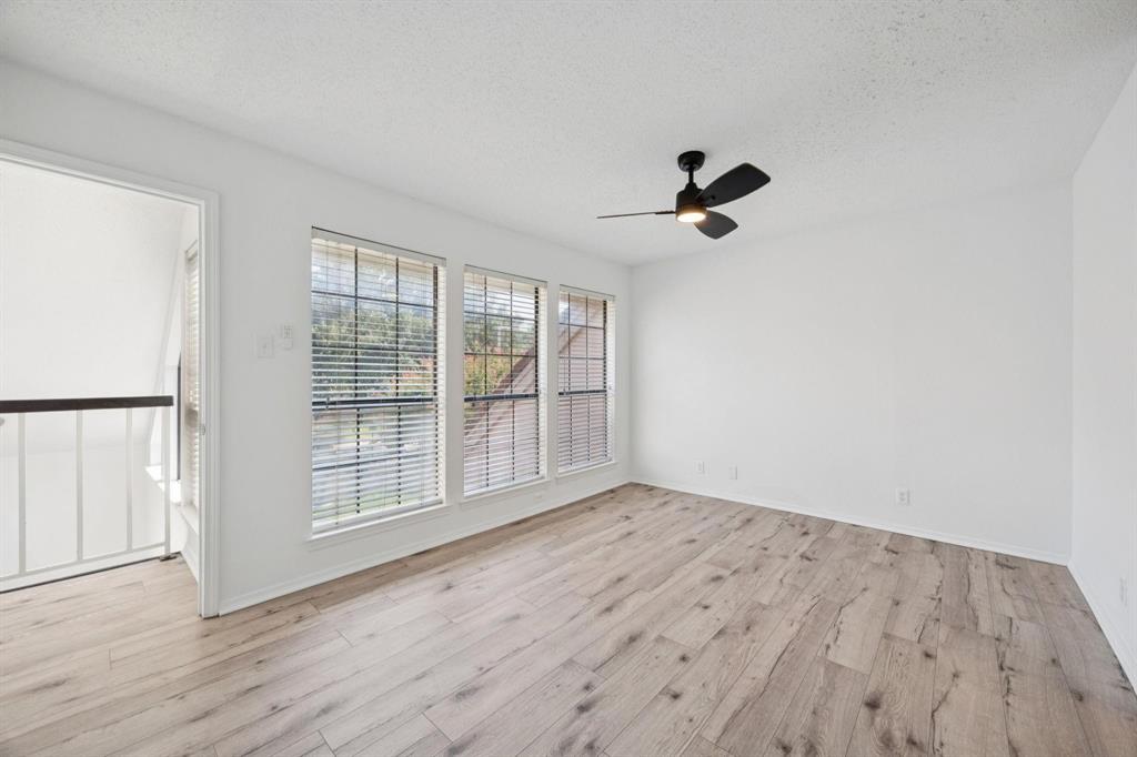 18240 Midway Road, Unit 904 Dallas, TX 75287 - Photo 14 of 26 wooden floor in an empty room with a window