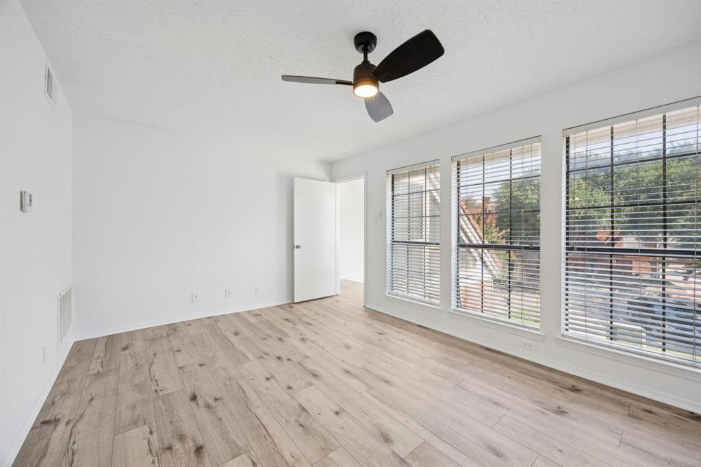 18240 Midway Road, Unit 904 Dallas, TX 75287 - Photo 16 of 26 an empty room with wooden floor and windows