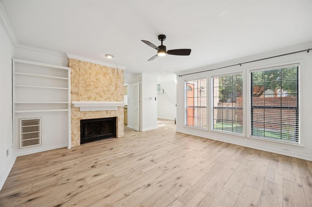18240 Midway Road, Unit 904 Dallas, TX 75287 - Photo 5 of 26 a view of an empty room with a fireplace and a window
