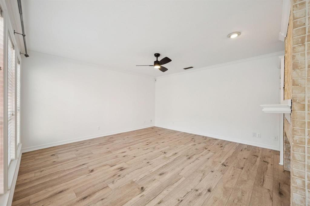 18240 Midway Road, Unit 904 Dallas, TX 75287 - Photo 6 of 26 a view of a room with wooden floor and a ceiling fan