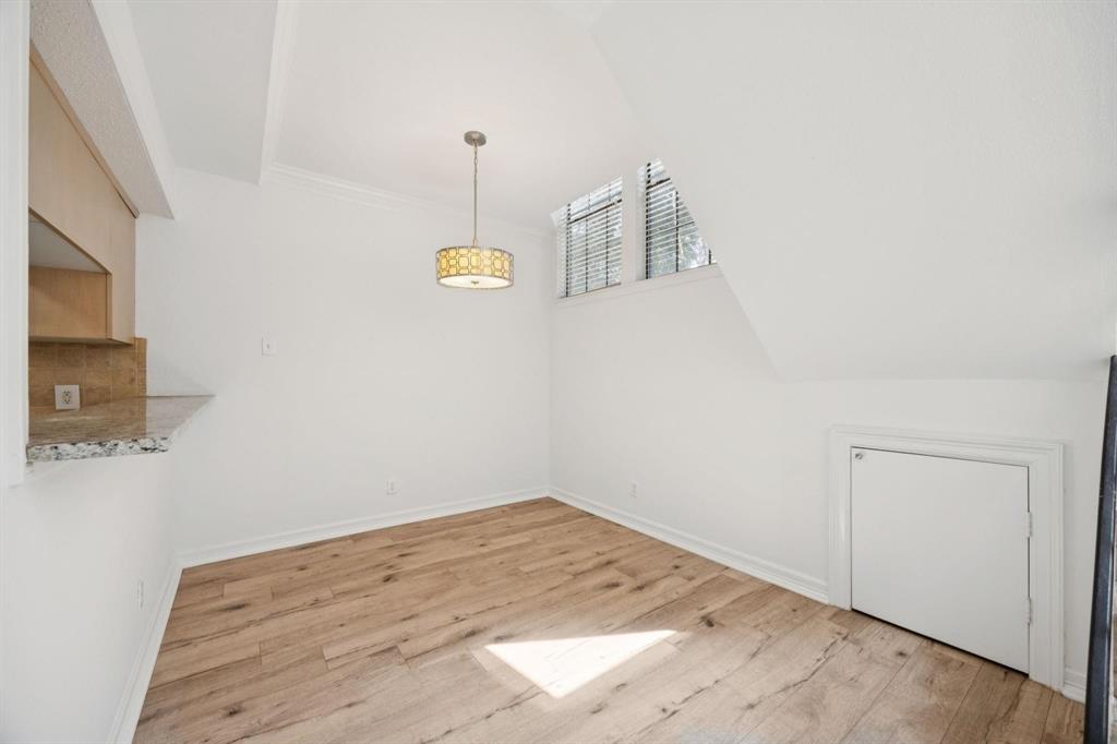 18240 Midway Road, Unit 904 Dallas, TX 75287 - Photo 8 of 26 a view of a room with wooden floor and ceiling fan