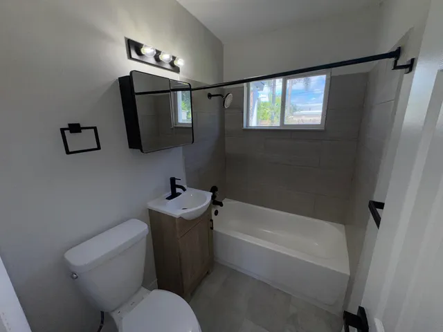 a bathroom with a sink toilet and mirror