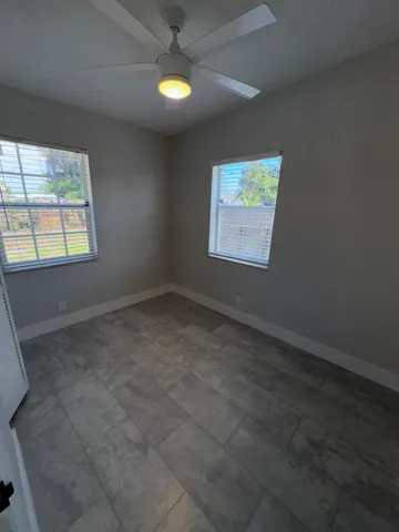 an empty room with windows and closet