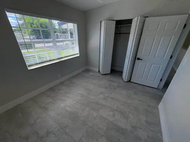 an empty room with windows and entrance