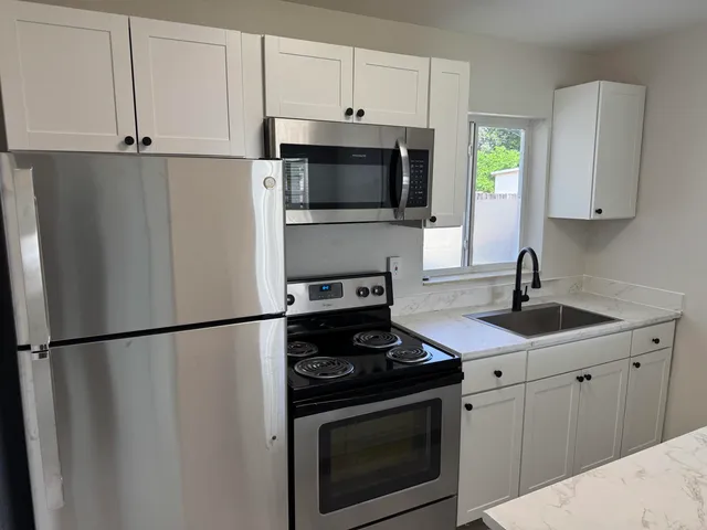 a kitchen with a sink a stove and refrigerator