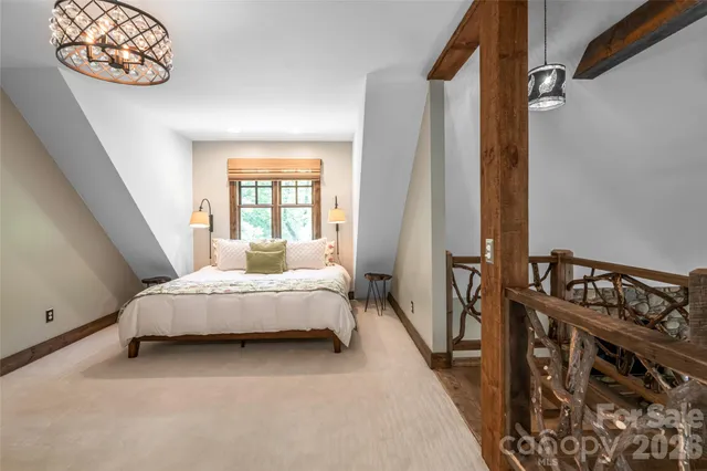a view of a wooden house with a large tree and wooden fence