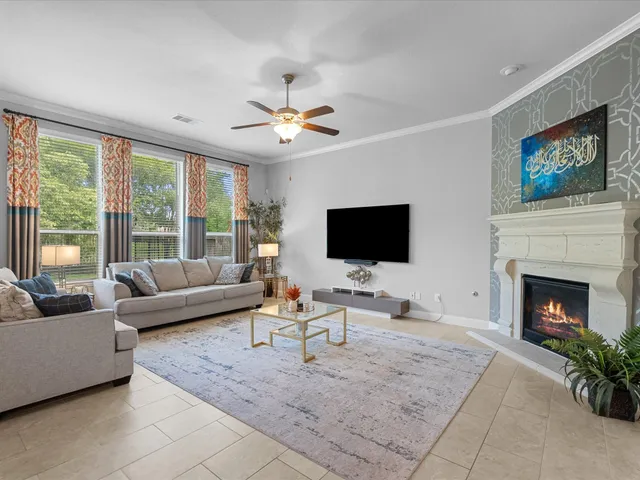 a living room with furniture a fireplace and a flat screen tv