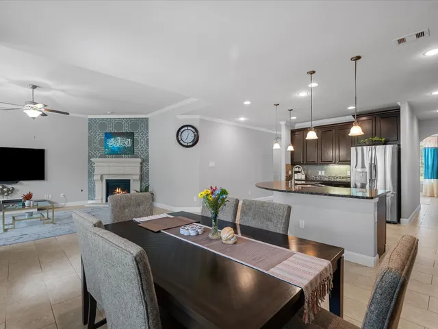 a kitchen with a dining table chairs and microwave