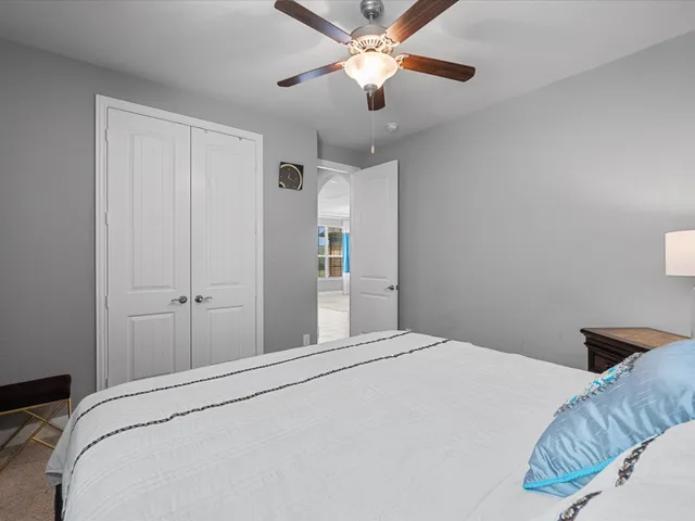 a bedroom with a large bed and a chandelier