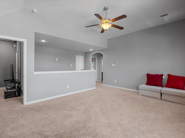 an empty room with projector and furniture