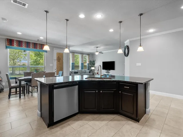 a kitchen with a sink a counter top space appliances and a floor