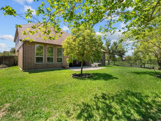 a view of a house with a yard porch and sitting area