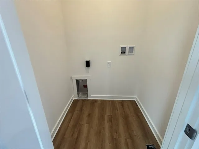 a kitchen with wooden floors white cabinets and appliances