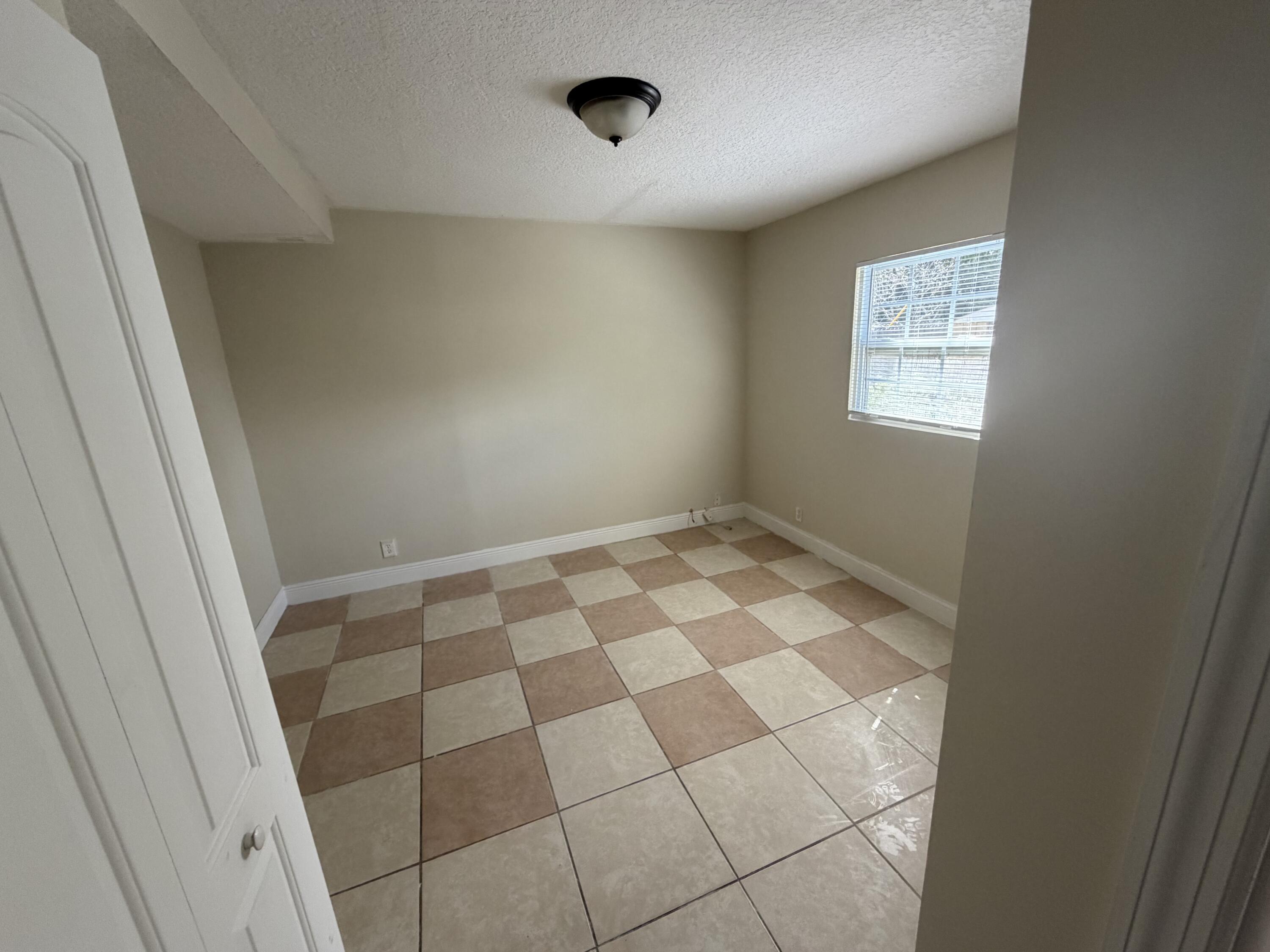 520 Seagrape Road Lantana, FL 33462 - Photo 13 of 16 a view of an empty room with a window