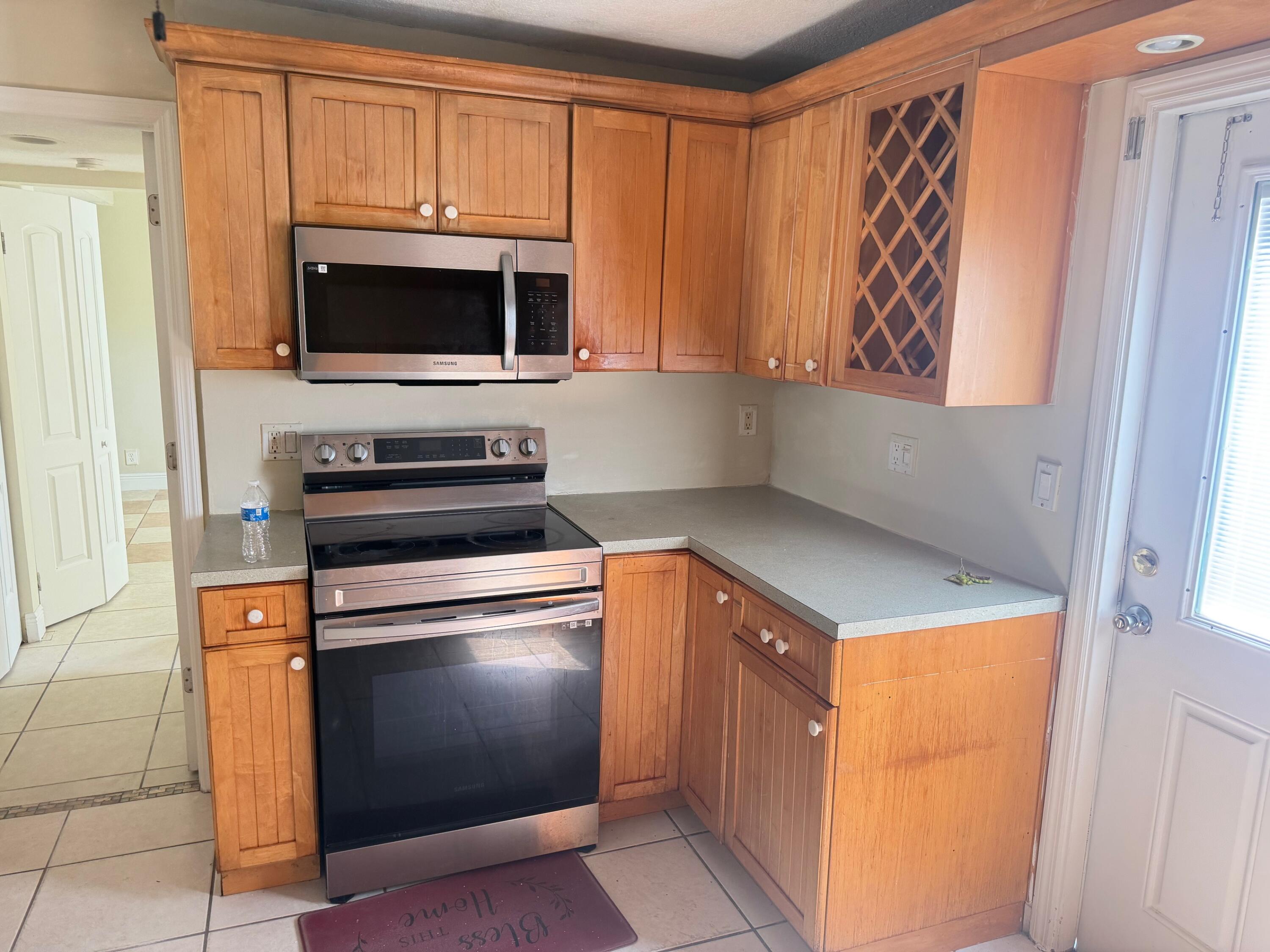 520 Seagrape Road Lantana, FL 33462 - Photo 5 of 16 a kitchen with stainless steel appliances a stove and a microwave