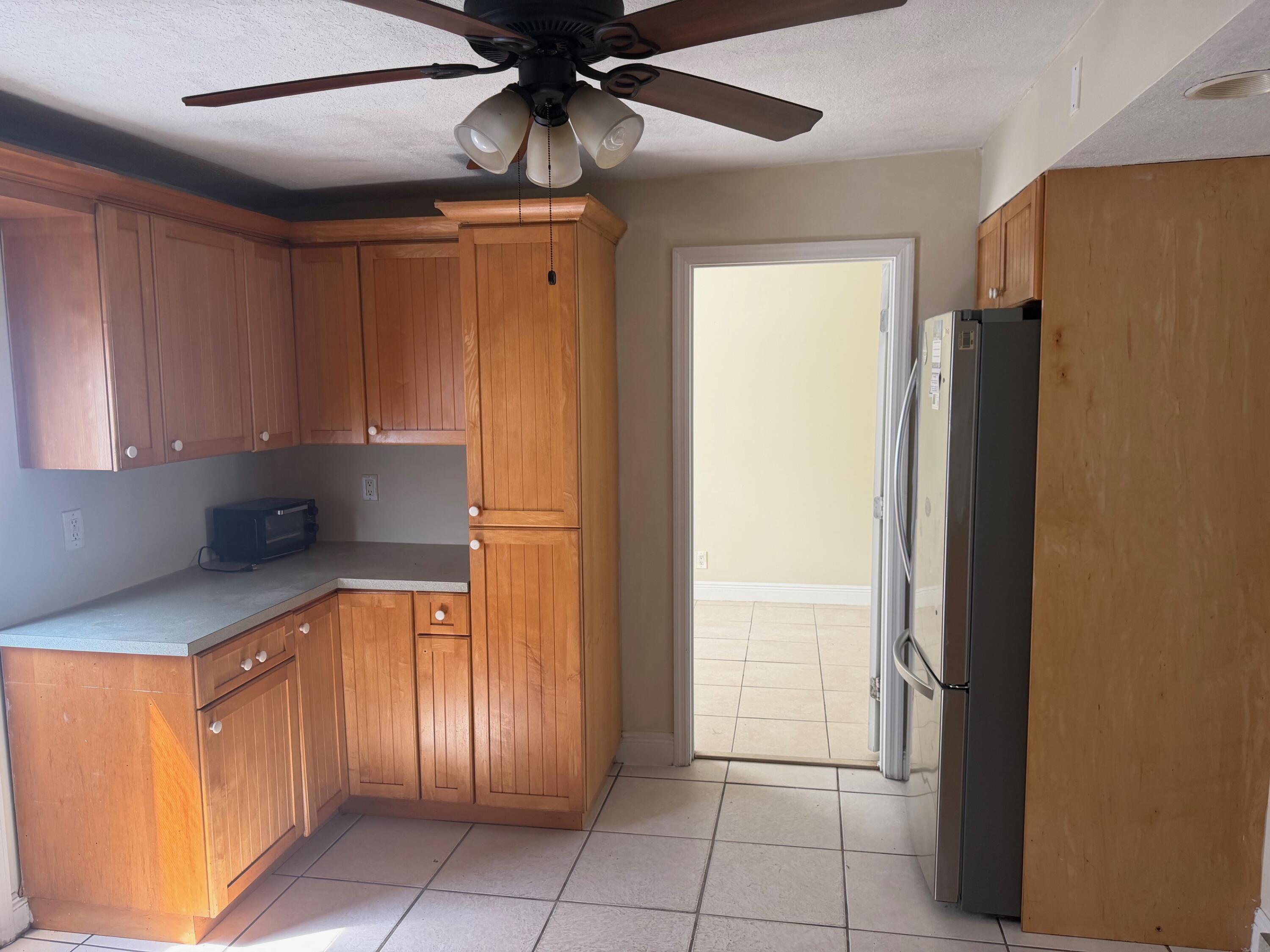 520 Seagrape Road Lantana, FL 33462 - Photo 6 of 16 a kitchen with stainless steel appliances a refrigerator and cabinets