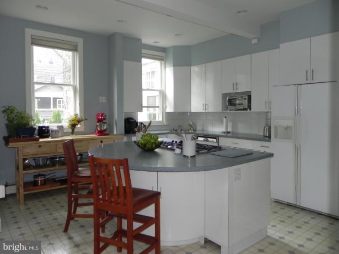 401 Hawthorn Road Baltimore, MD 21210 - Photo 8 of 26 a kitchen with sink a window and chairs