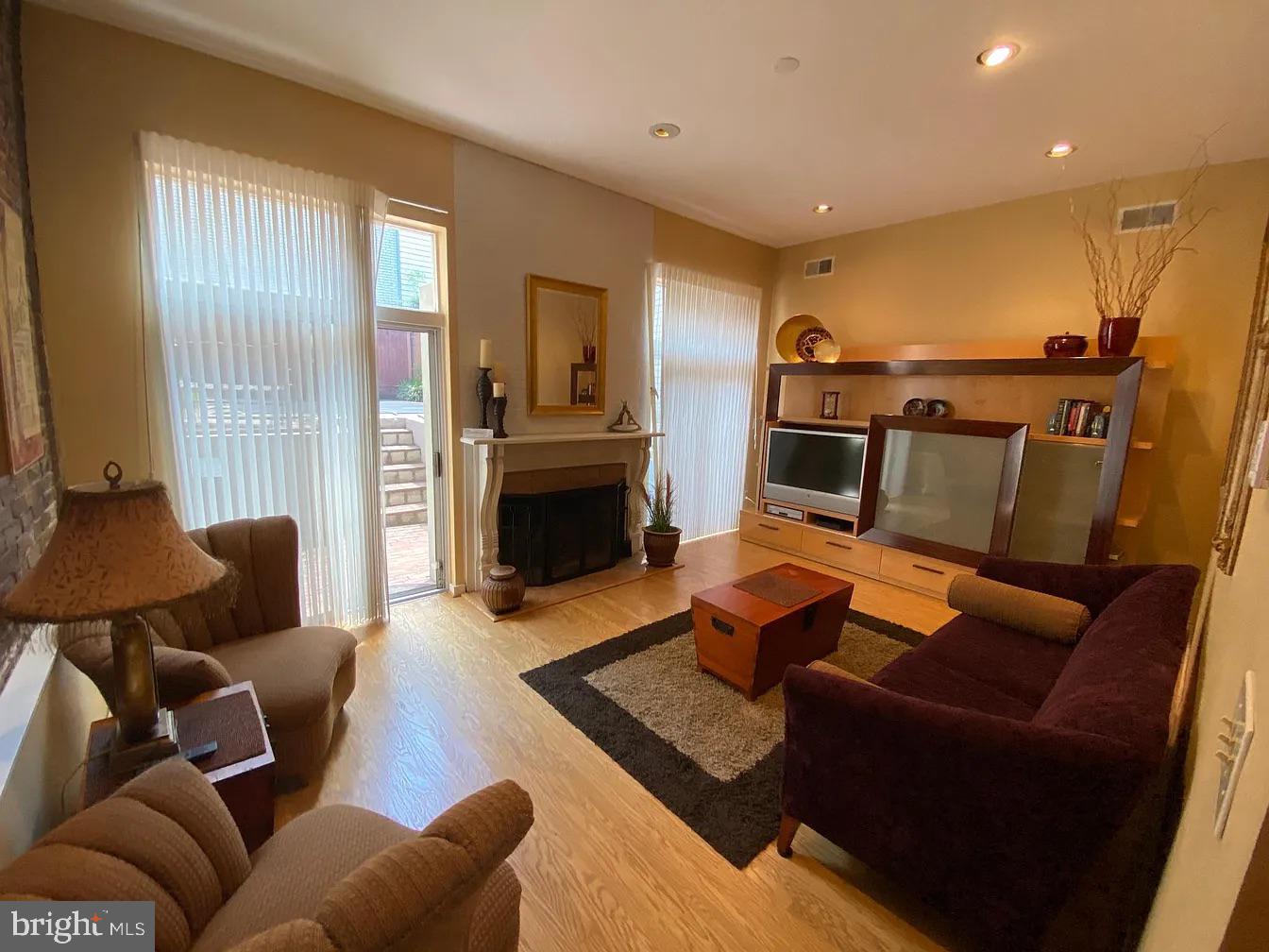 825 F Street Northeast Washington, DC 20002 - Photo 11 of 31 a living room with furniture and a fireplace