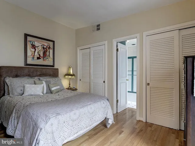 a bedroom with bed and wooden floor