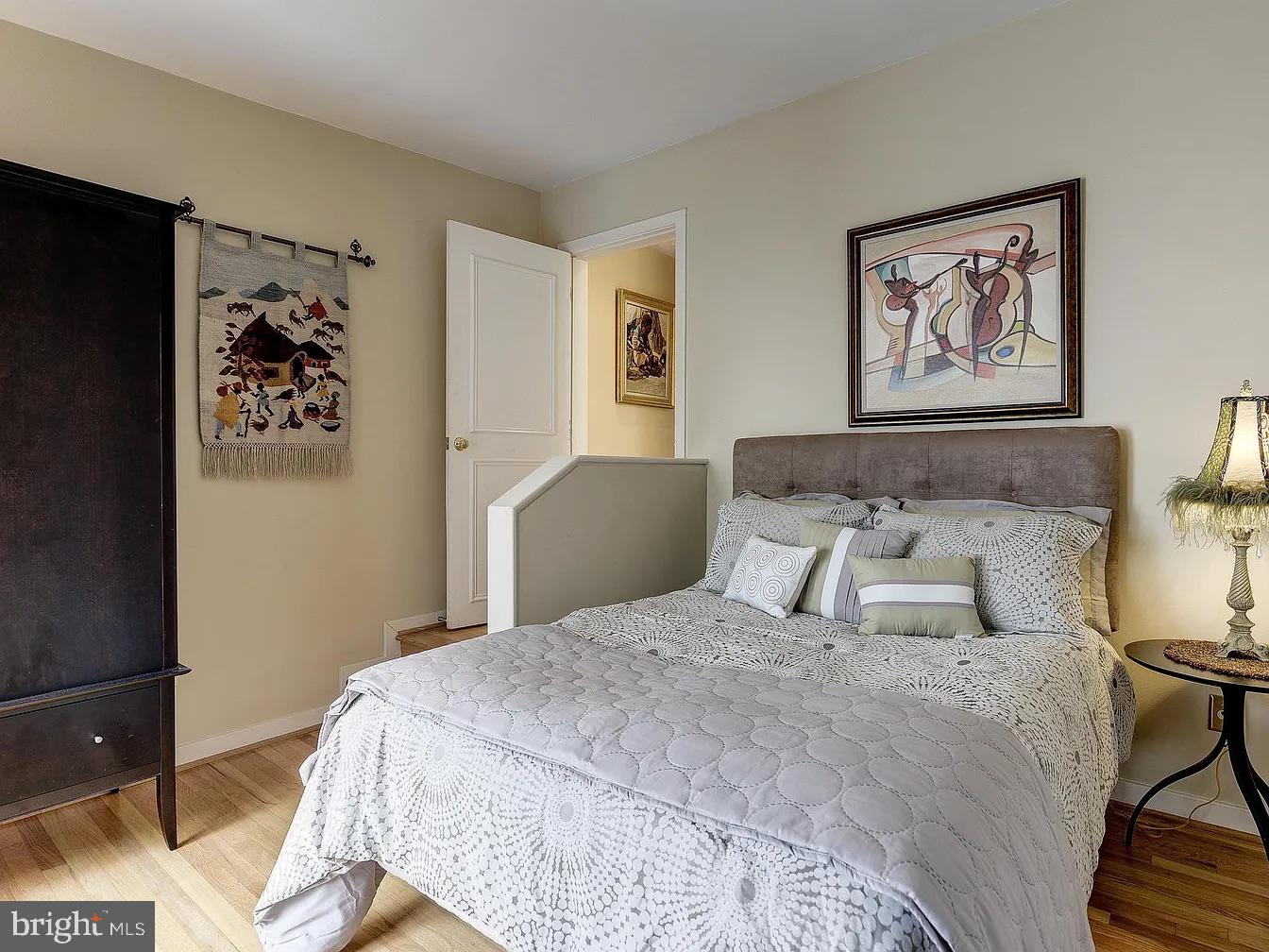 825 F Street Northeast Washington, DC 20002 - Photo 18 of 31 a bedroom with a bed and a painting on the wall