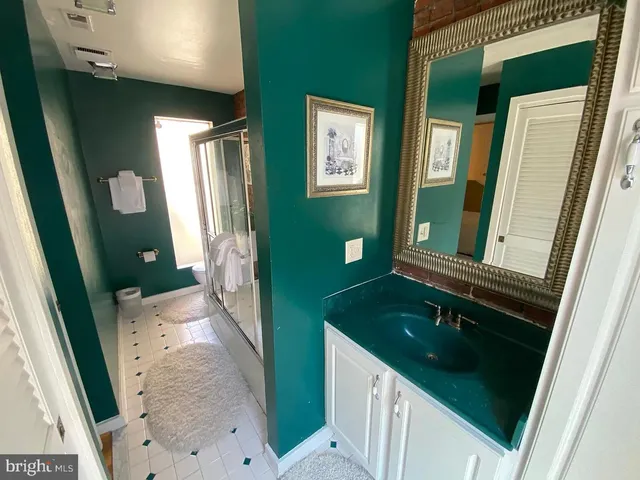 a bathroom with a double vanity sink and mirror
