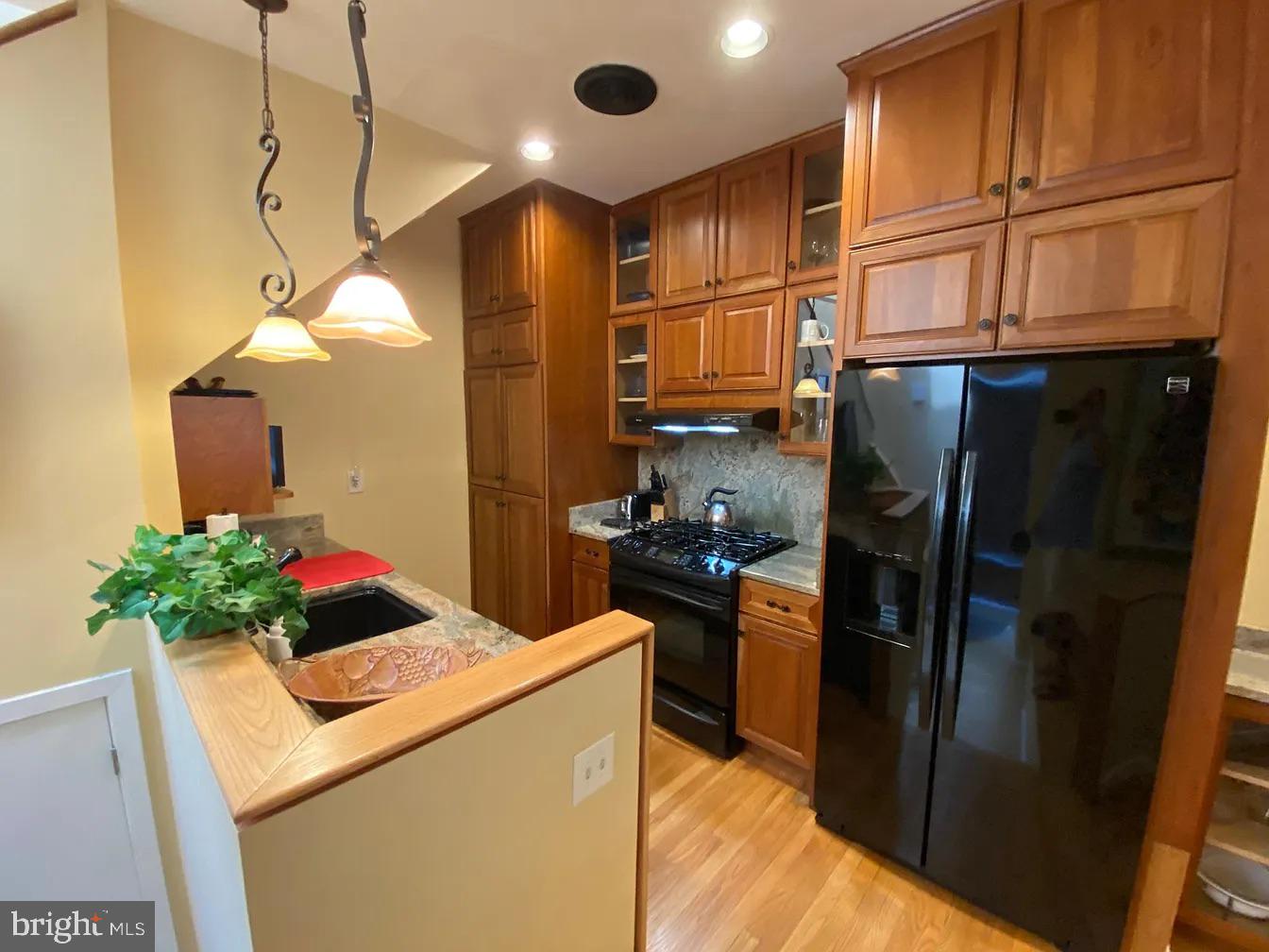 825 F Street Northeast Washington, DC 20002 - Photo 4 of 31 a kitchen with stainless steel appliances kitchen island granite countertop a refrigerator a stove and a sink