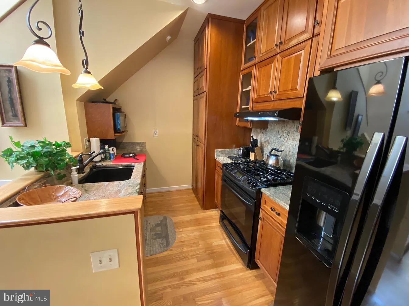 825 F Street Northeast Washington, DC 20002 - Photo 5 of 31 a kitchen with a sink stove and refrigerator