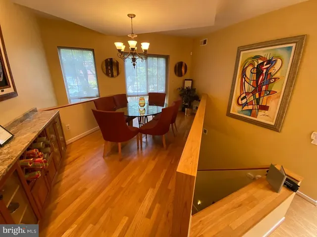 a dining room with furniture and chandelier