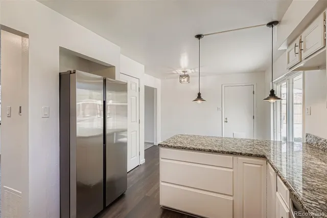 a bathroom with a granite countertop sink a shower and a mirror