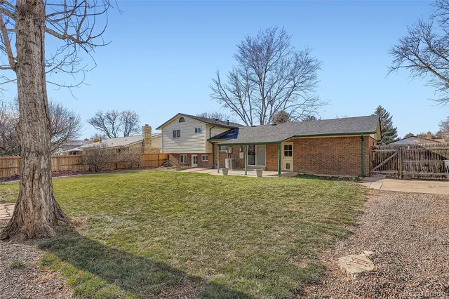 a kitchen with a sink cabinets a stove and a window