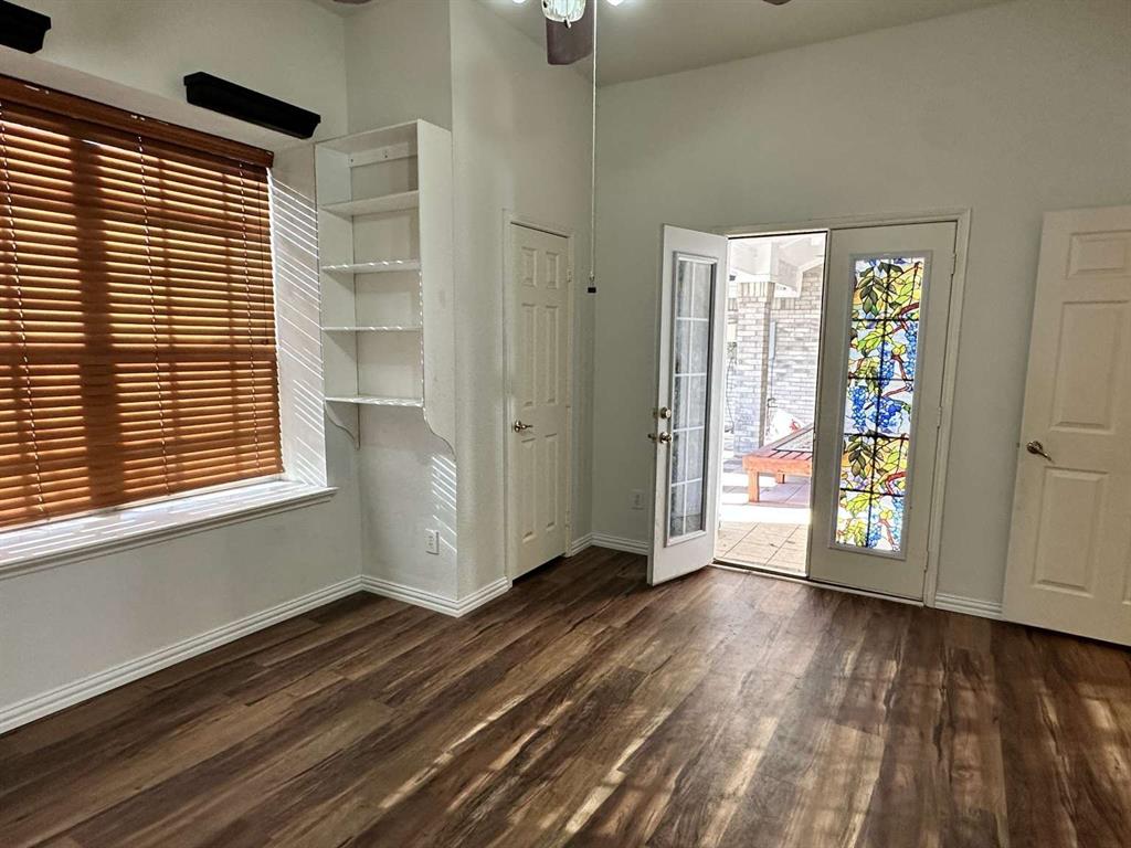 5713 Allen Lane Rowlett, TX 75088 - Photo 13 of 20 a view of an empty room with window and wooden floor