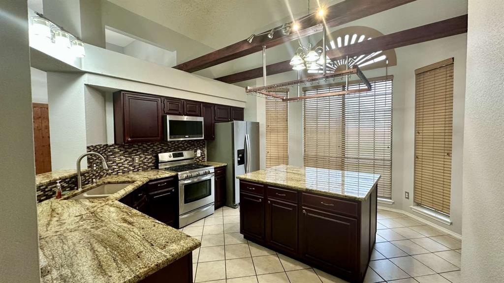 5713 Allen Lane Rowlett, TX 75088 - Photo 9 of 20 a large kitchen with a stove and a sink