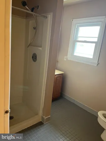 a bathroom with a shower and a sink