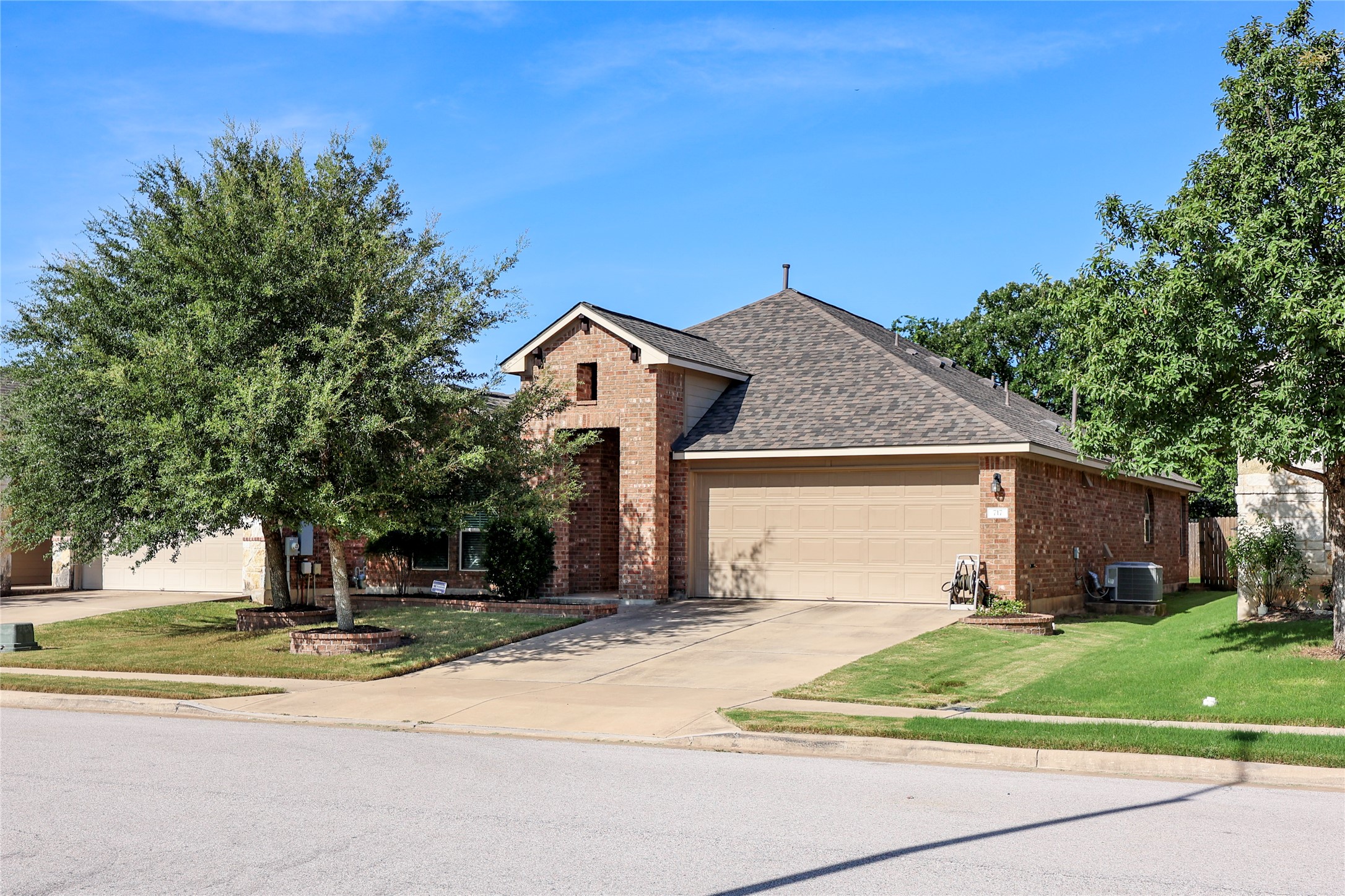 717 Schefer Street Leander, TX 78641 - Photo 1 of 27 a front view of a house with a yard and garage