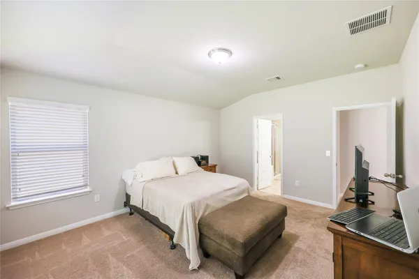 a bedroom with a bed and a dresser