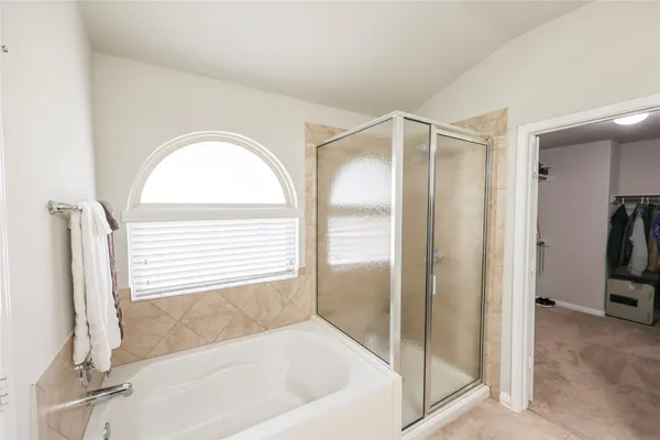 a bathroom with a bathtub and a shower