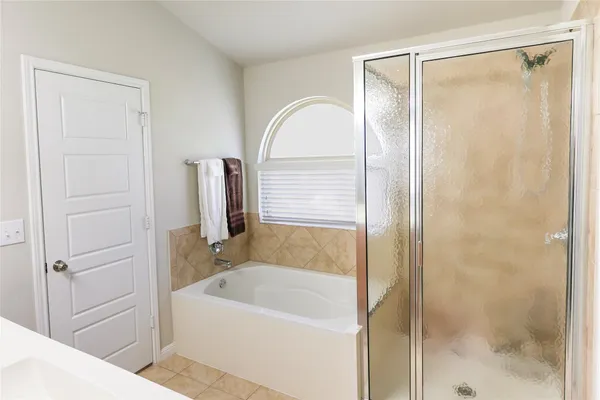 a bathroom with a bathtub and a shower