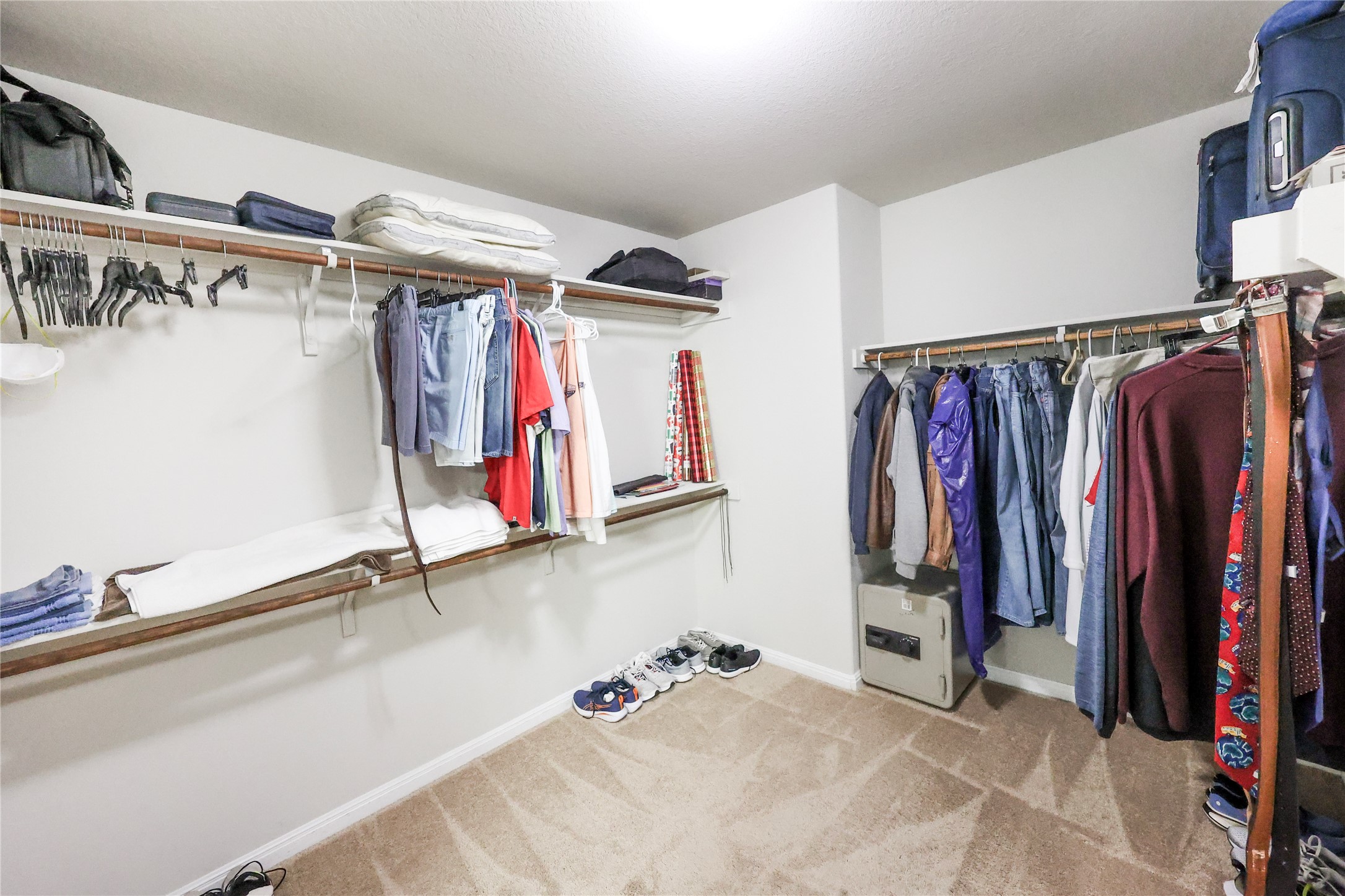 717 Schefer Street Leander, TX 78641 - Photo 17 of 27 a view of walk in closet with clothes