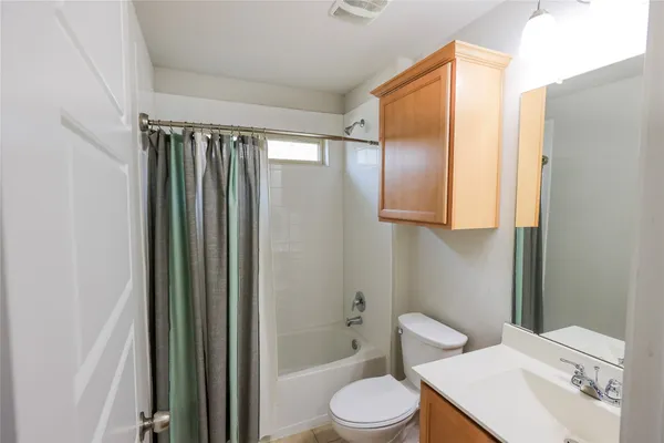 a bathroom with a toilet a sink and bathtub