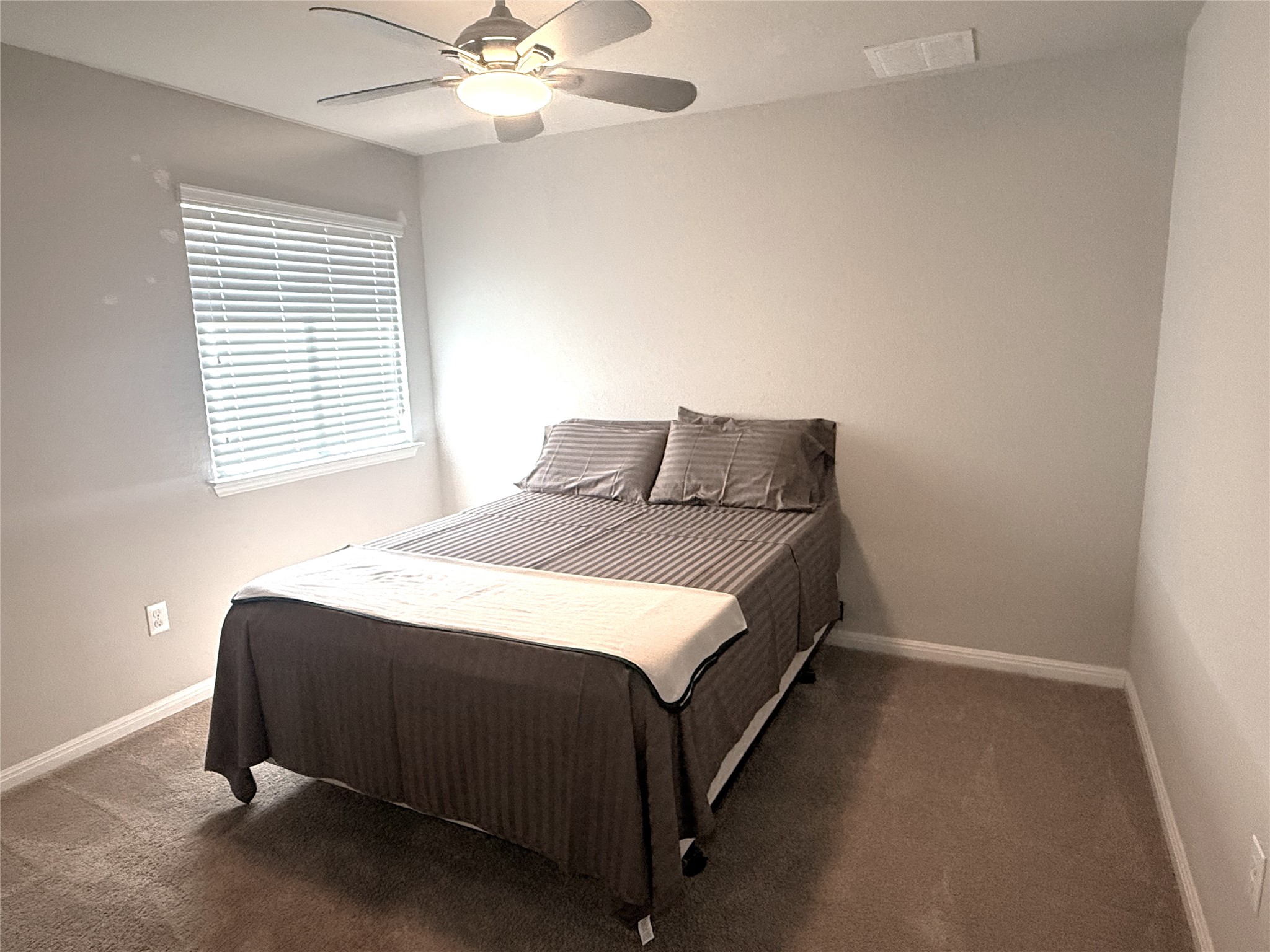 717 Schefer Street Leander, TX 78641 - Photo 20 of 27 a bedroom with a bed and window