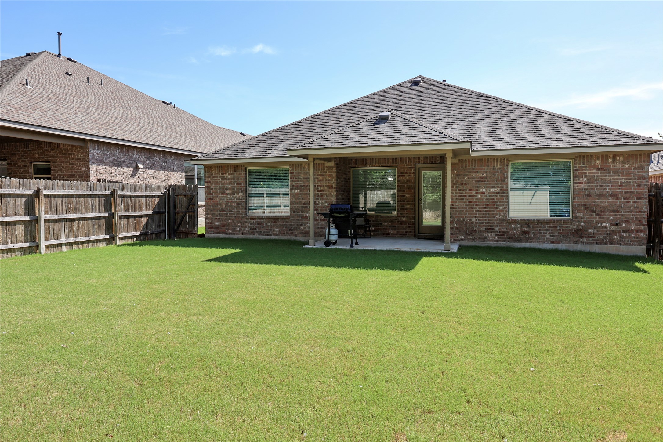 717 Schefer Street Leander, TX 78641 - Photo 24 of 27 a front view of a house with a garden and yard