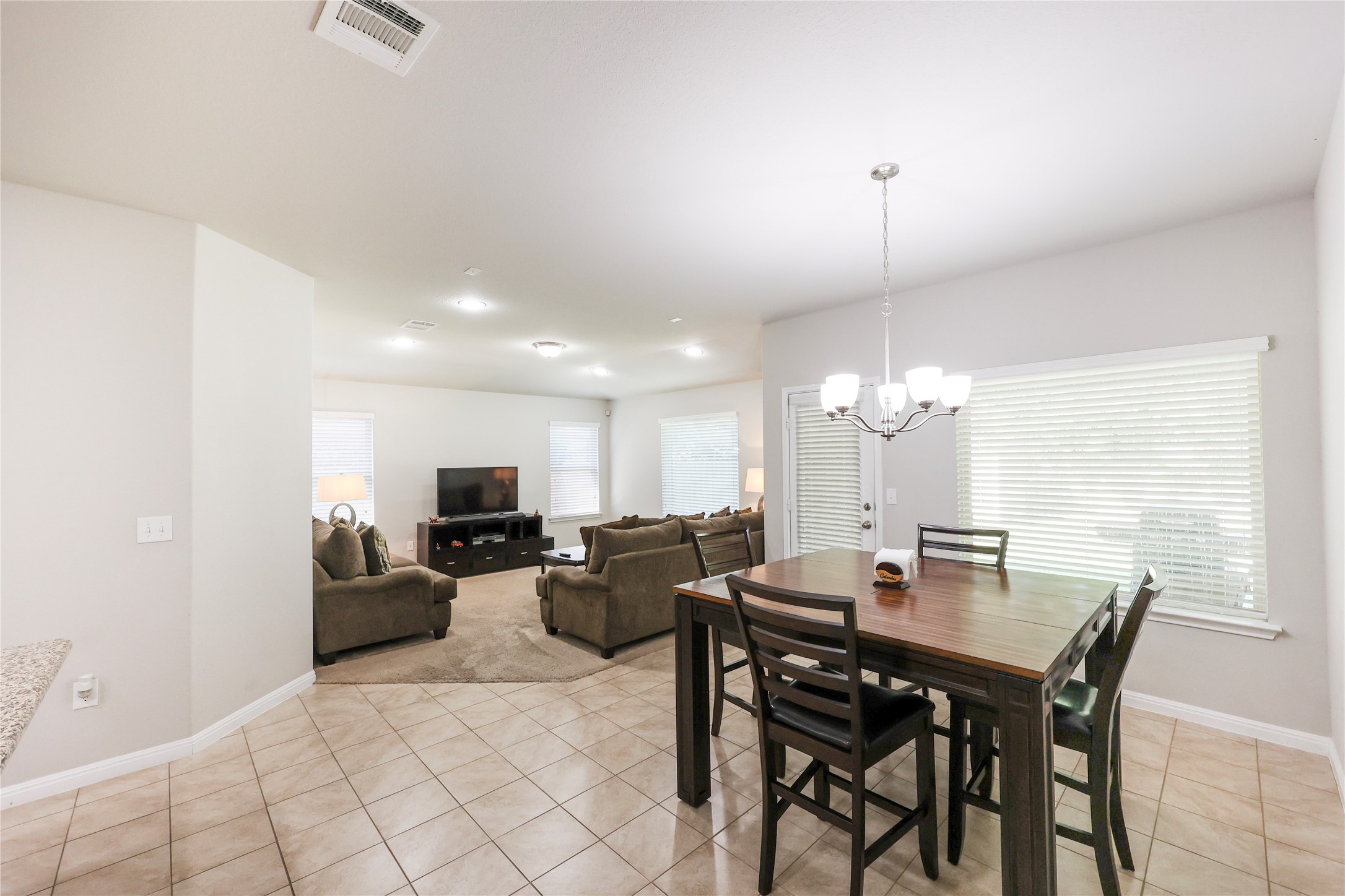717 Schefer Street Leander, TX 78641 - Photo 3 of 27 a view of a dining room with furniture