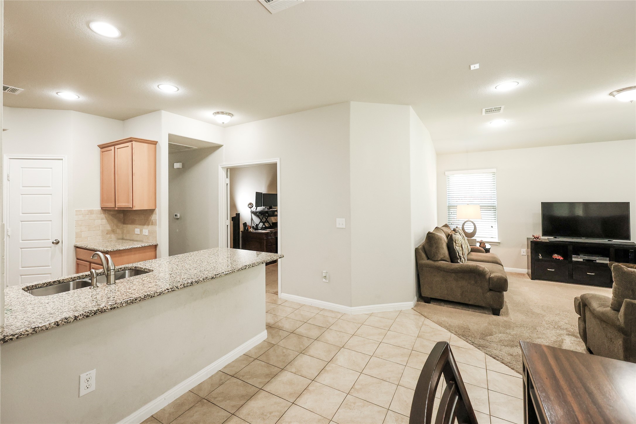 717 Schefer Street Leander, TX 78641 - Photo 4 of 27 a living room with furniture and a flat screen tv