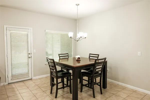 a view of a dining room with furniture and window