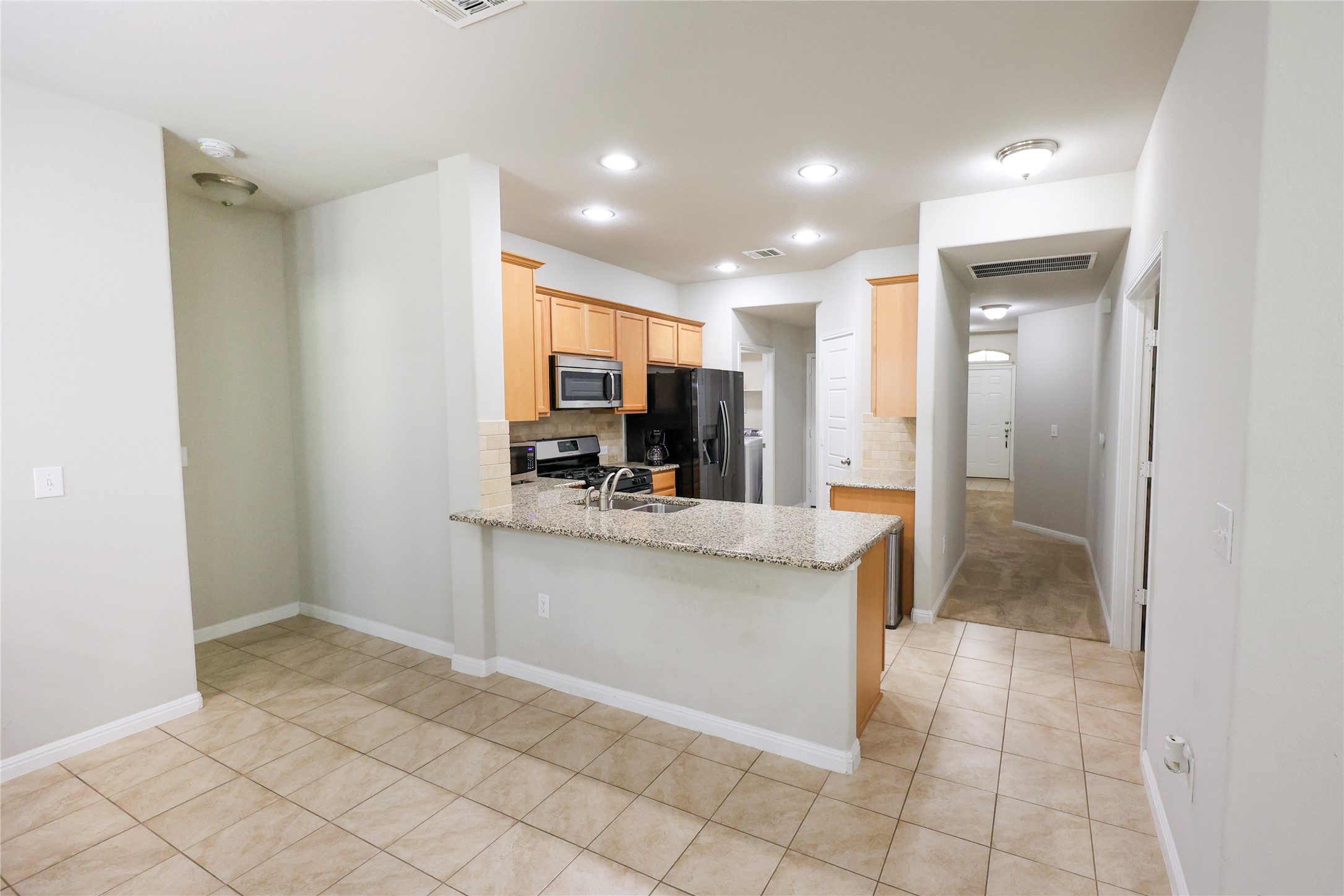 717 Schefer Street Leander, TX 78641 - Photo 6 of 27 a view of kitchen with granite countertop cabinets and window